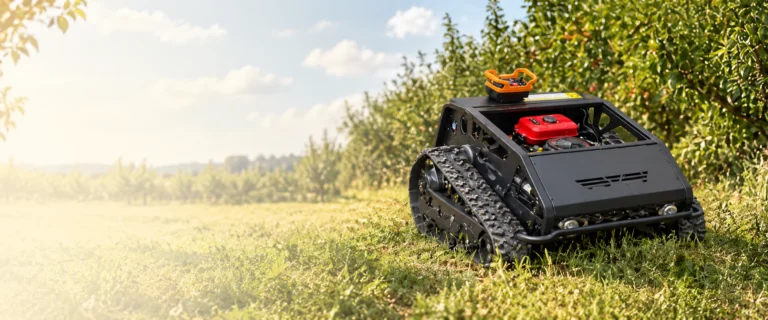 Tracked mower cutting grass between orchard trees